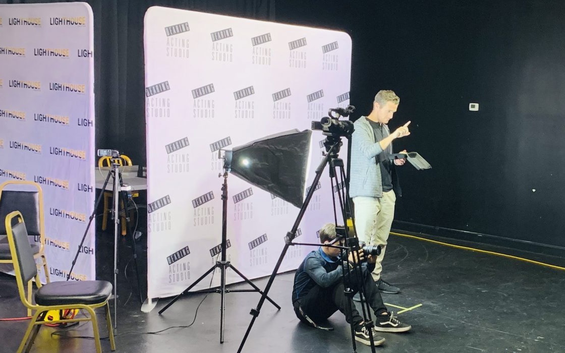 A casting session in progress at the Phoenix Casting suite: camera on tripod, softbox lighting and an actor reading sides